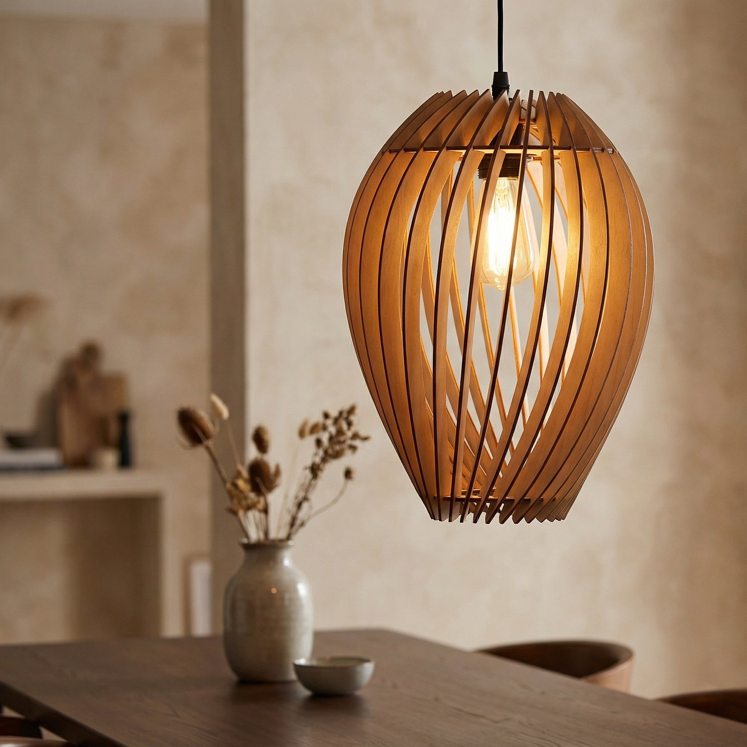 Wooden pendant light hanging above a table with a neutral background