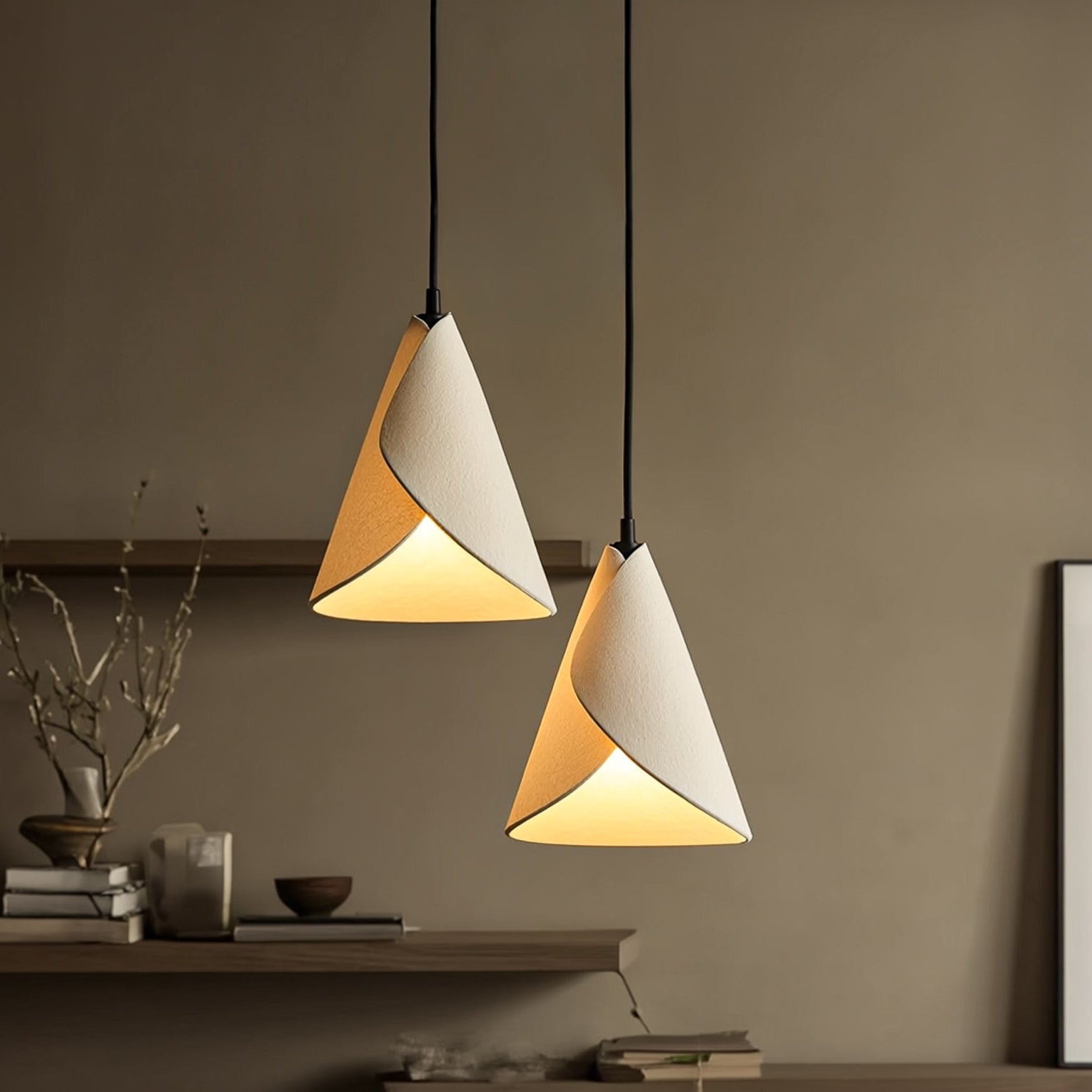 Two cone-shaped pendant lights hanging against a neutral wall.